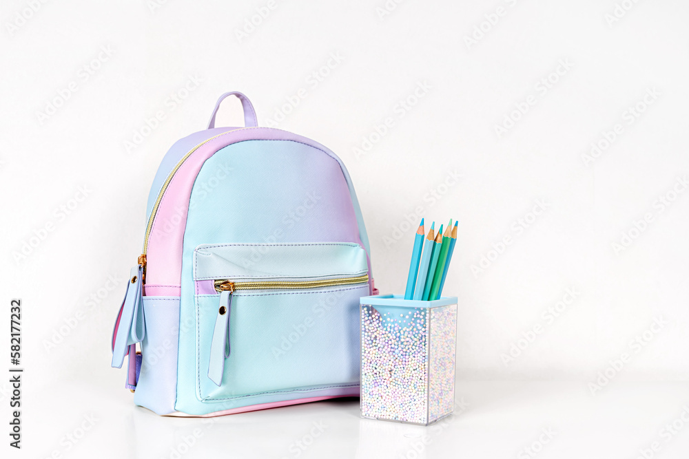 School backpack and pencil holder with color pencils on the table. Creative Organizing. Concept back to school. Stationery and supplies for drawing and creativity. School backpack and pencil holder with color pencils on the table. Creative Organizing. Concept back to school. Stationery and supplies for drawing and creativity.