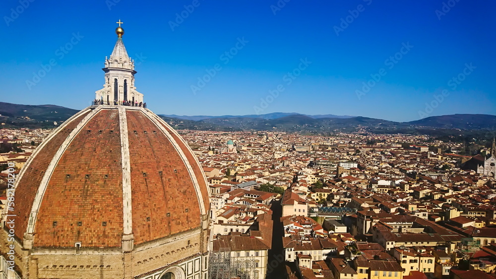 Firenze, Italy - April 7, 2018: aerial view of Florence cityscape and skyline with Brunelleschi's Dome on the left under bright blue clear sky