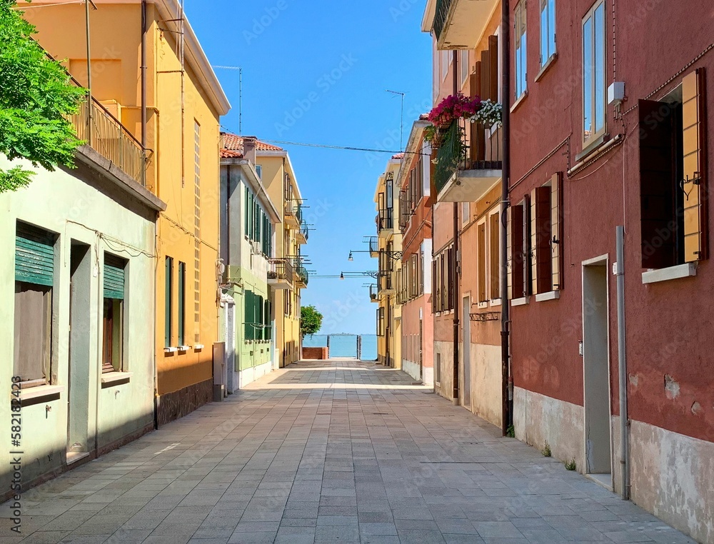 Beautiful shot of a sunny alley with stone buildings in Murano, Italy