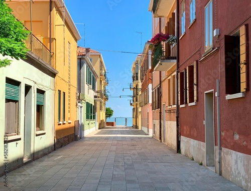 Beautiful shot of a sunny alley with stone buildings in Murano, Italy © Nigel Harris/Wirestock Creators