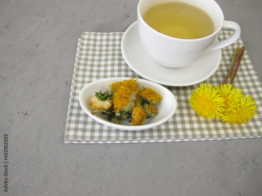 A cup of tea from dried dandelion flowers A cup of tea from dried dandelion flowers