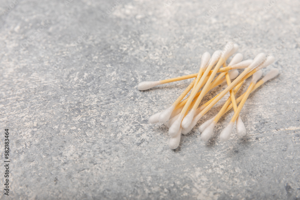 Cotton buds on a light concrete background.Eco-friendly materials. Wooden, cotton swabs on a white background.Bamboo swabs and cotton flowers.Zero waste, plastic free lifestyle concept.Place for text. Cotton buds on a light concrete background.Eco-friendly materials. Wooden, cotton swabs on a white background.Bamboo swabs and cotton flowers.Zero waste, plastic free lifestyle concept.Place for text.
