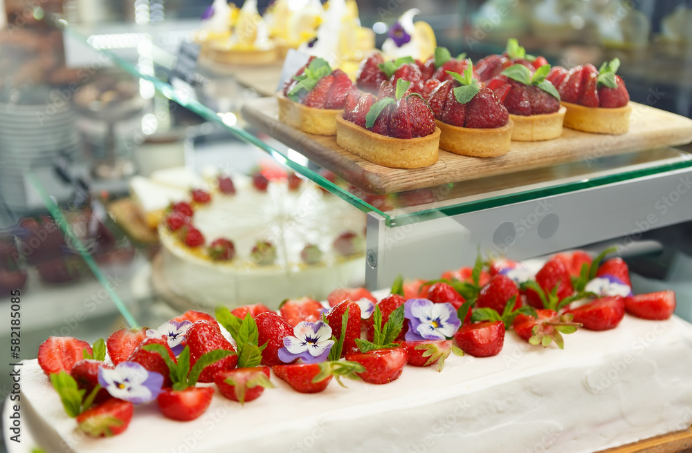 Delicious strawberry cheesecake and tart cupcakes with fresh strawberries prepared for lunch in a pastry cafe. No people Delicious strawberry cheesecake and tart cupcakes with fresh strawberries prepared for lunch in a pastry cafe. No people