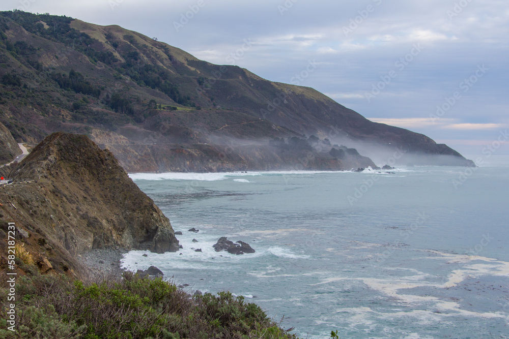 The rocky California coastline as off the Pacific Coast Highway near the Big Sur area. Classic foggy conditions and rough waters. The rocky California coastline as off the Pacific Coast Highway near the Big Sur area. Classic foggy conditions and rough waters.