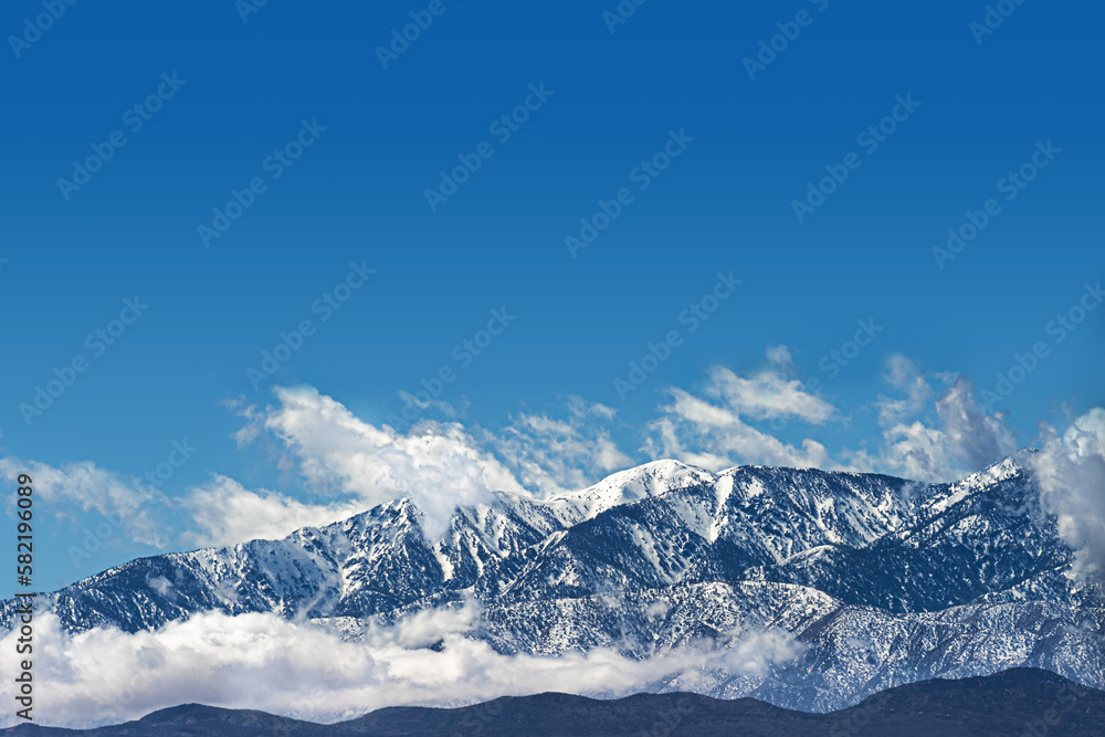 Clouds at snow capped mountain range in Southern California Clouds at snow capped mountain range in Southern California