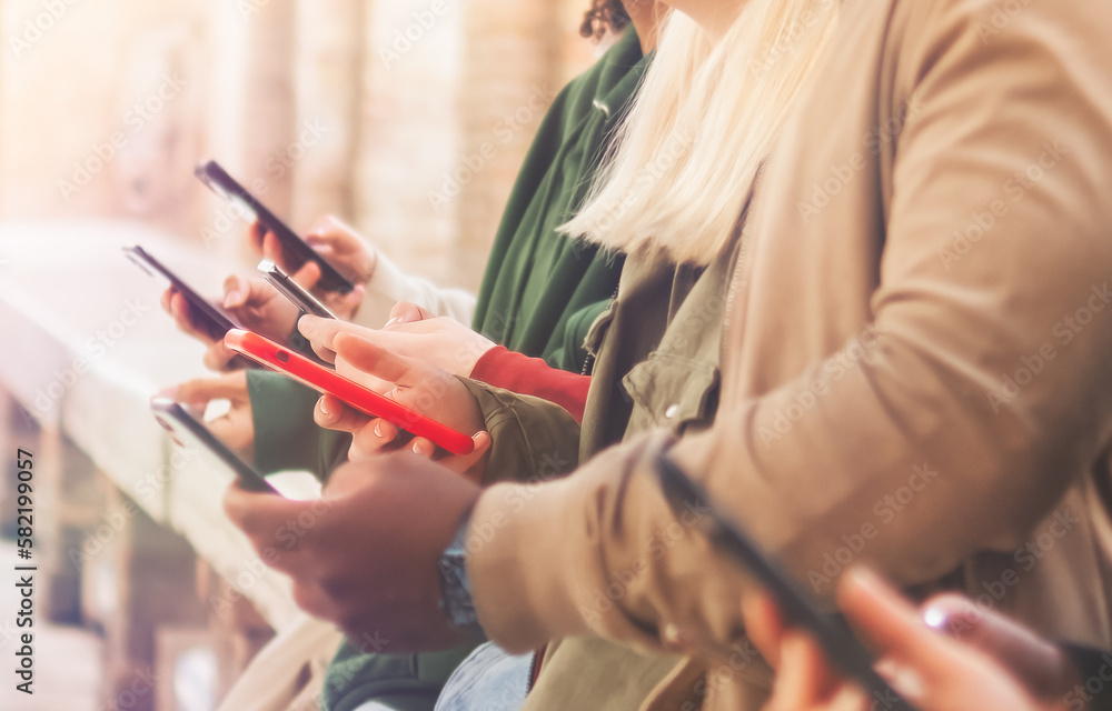 Fototapeta premium Closeup of Millennial Friends Group Using Modern Smartphones - Business Startup Youth Lifestyle, Friendship and Teamwork Concept - Selective Focus.