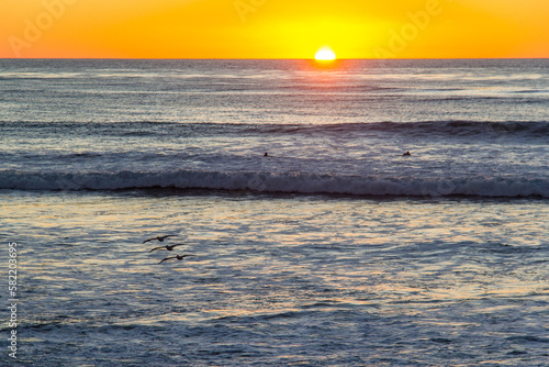 Sun setting over the Pacific Ocean at El Matador State Beach in Malibu, California