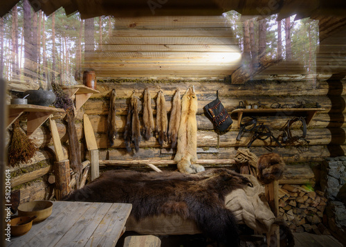 A fabulous blurred vision of the Siberian taiga in an old log hut of a hunter
