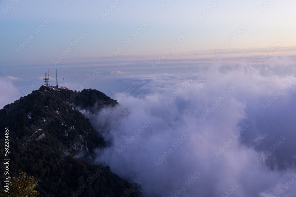 Watching the sunset over the clouds, looking over the city of Los Angeles. Views from Angeles National Forest