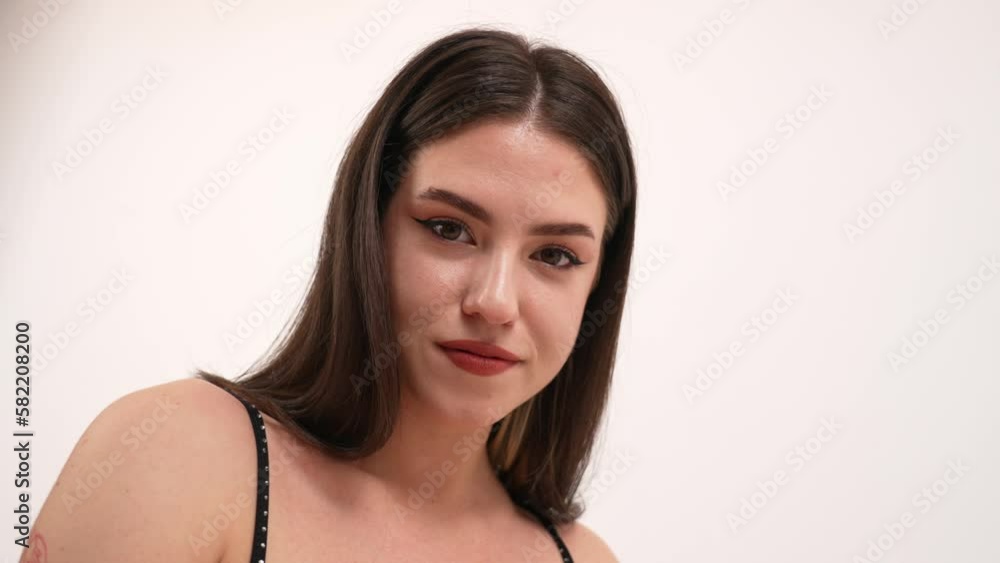 closeup view of a nice-looking dancer cheerleader in a black dress, studio shot. High quality 4k footage closeup view of a nice-looking dancer cheerleader in a black dress, studio shot. High quality 4k footage