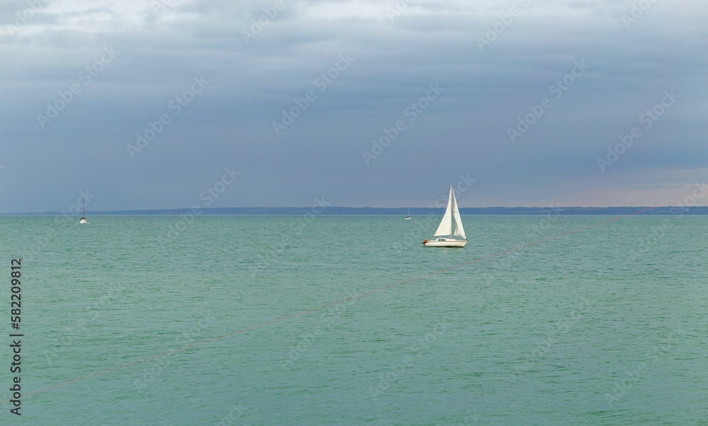Boat in the sea with a cloudy sky in the background