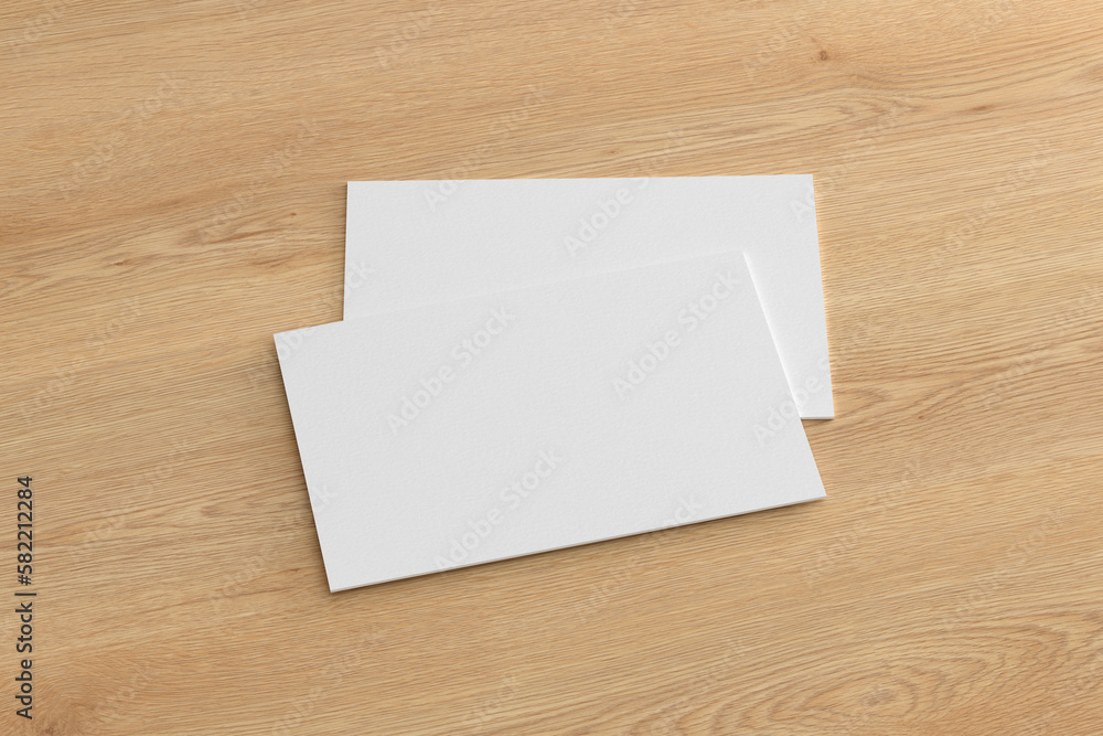 Business card mockup. Pair of business card on wooden background. Side view Business card mockup. Pair of business card on wooden background. Side view