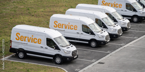 Service vans are parked in row. Commercial fleet