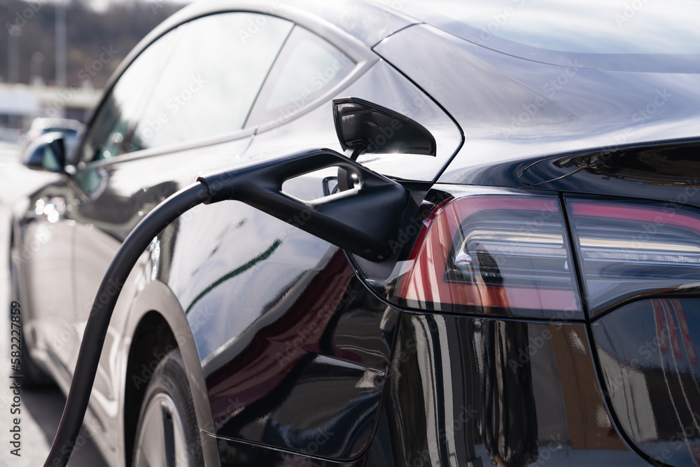 Close-up of an electric car with a charging cable Close-up of an electric car with a charging cable