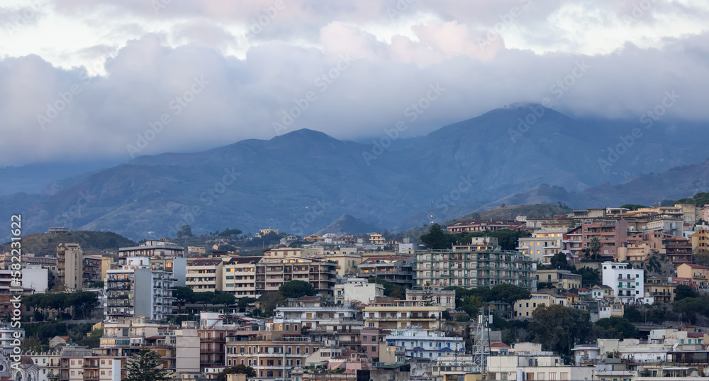 Homes and Apartment Buildings in a touristic city Messina, Sicilia, Italy. Cloudy Sunrise Sky. Aerial