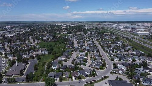 mid-day summer panoramic views over a small city with lush greenery and happy modest houses photo