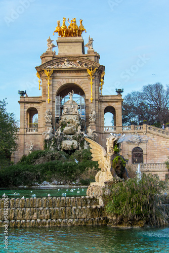 Ornate architecture with golden statues on top in a park in Barcelona, Spain.