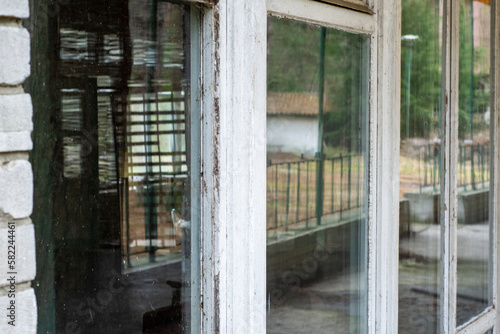An interesting view of old windows in a forgotten building in the style of the 80's, urbex. day.