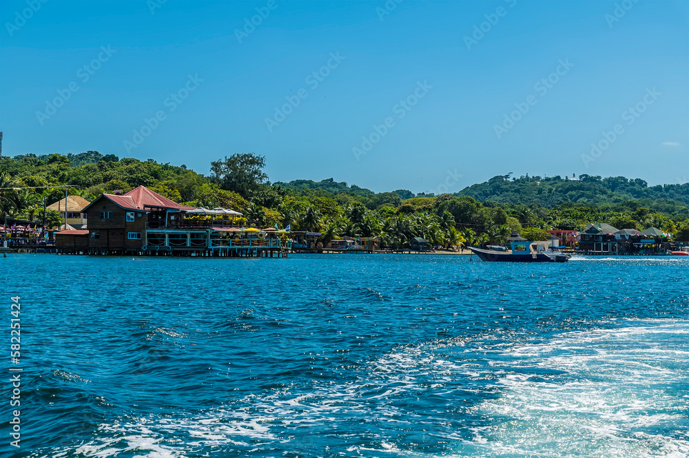 A view from a boat leaving West Bay on Roatan Island on a sunny day