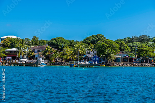 A view of boats and buildings at West Bay on Roatan Island on a sunny day