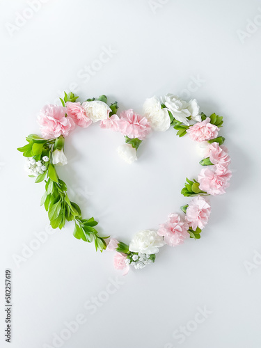 Frame in form of heart from pink, white carnations