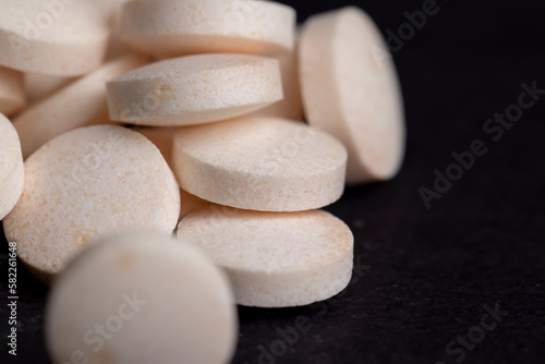 White and yellow medical medicines on a black background