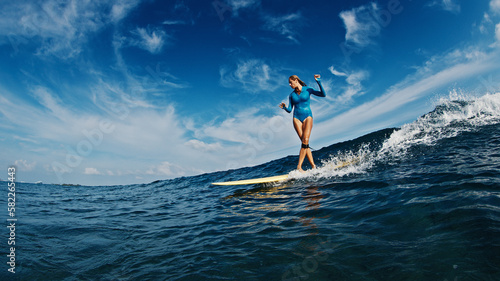 Photography Slim woman surfer rides the wave