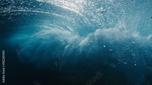 Underwater view of the ocean wave breaking on the shore in the Maldives