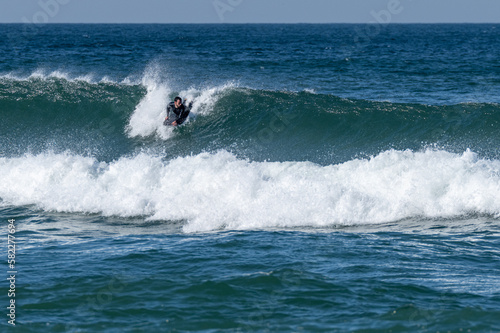 Bodyboarder surfing ocean wave