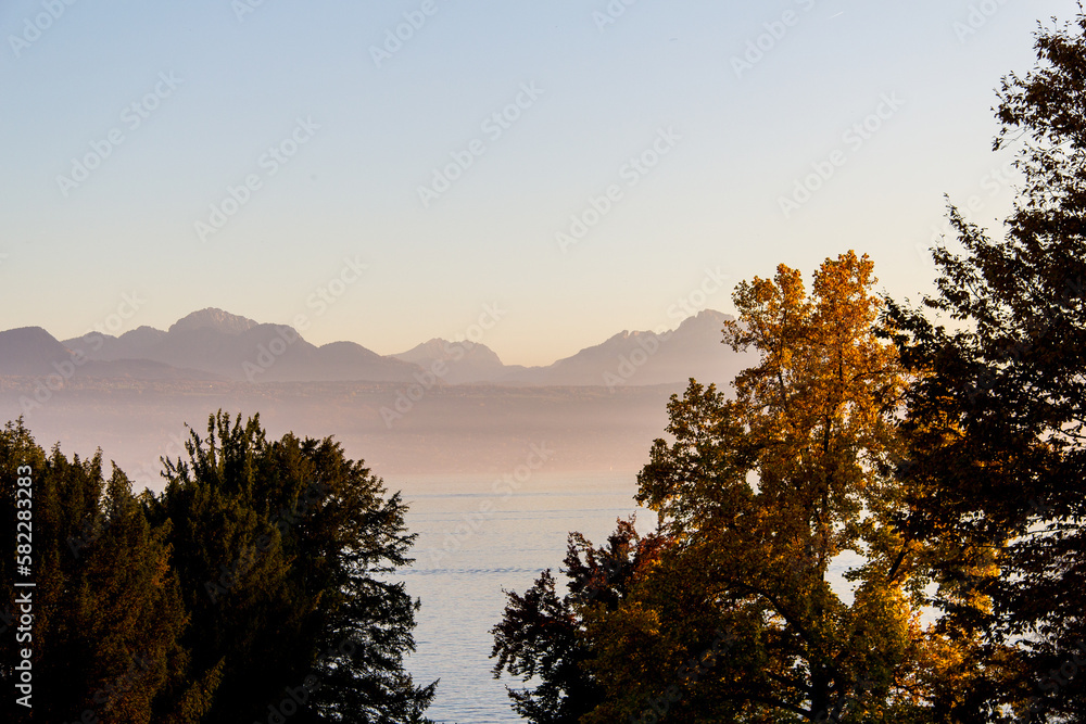 Sunsetting over a marina in Lausanne, Switzerland with the large mountains in the background of the lake.
