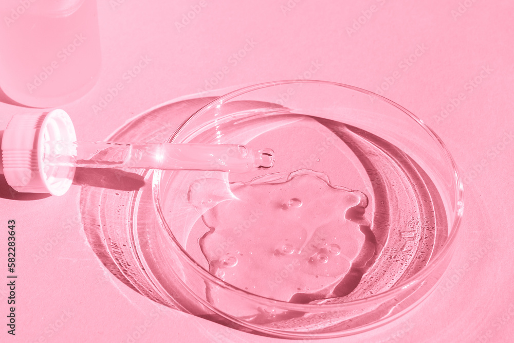 Petri dish. With transparent gel. With a pipette. Cosmetics bottle. On a pink background. Petri dish. With transparent gel. With a pipette. Cosmetics bottle. On a pink background.