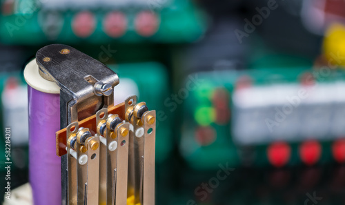 Fényképezés Power electromechanical relay and blurry electronic components on colored background with bokeh
