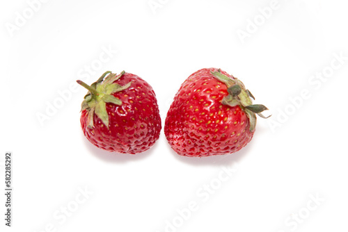 Two fresh ripe strawberries on a white background. Beautiful and tasty strawberries. Dessert. Close-up