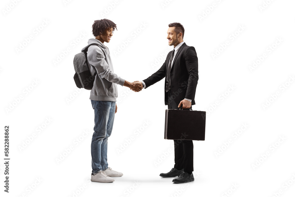© Ljupco Smokovski - Full length profile shot of an african american young man  shaking hands with a businessman