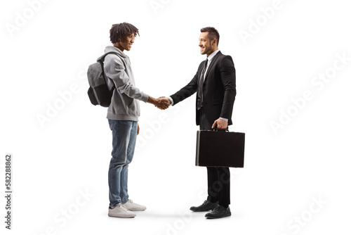 Full length profile shot of an african american young man  shaking hands with a businessman