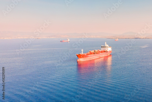 Industrial crude oil tanker anchored in deep blue open ocean sea, Wide aerial view