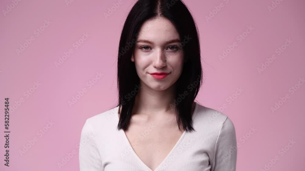 4k video of one girl posing for a video over pink background. 4k video of one girl posing for a video over pink background.
