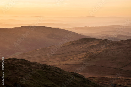 Lovely Winter landscape view from Red Screeds across misty layers of mountains towards the East