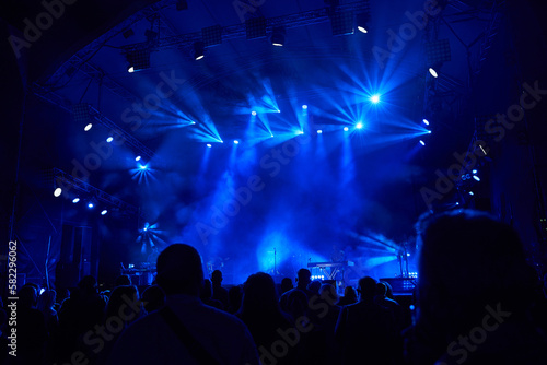Colourful concert arena with a crowd silhouette against stage lights. silhouettes of the audience against the background of the concert stage