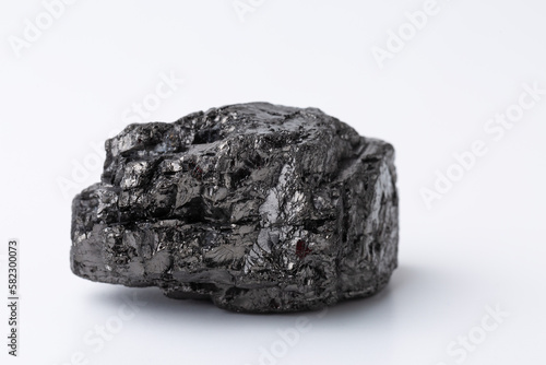Natural black fossil coal on a white isolated background.