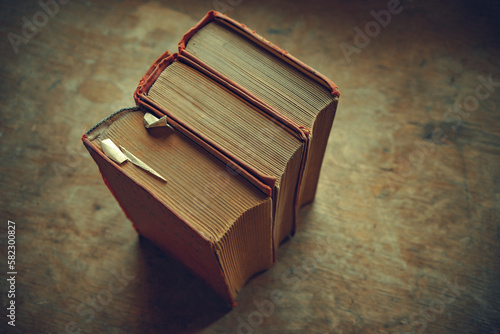 Quadro em tela Three large antique books on a wooden table