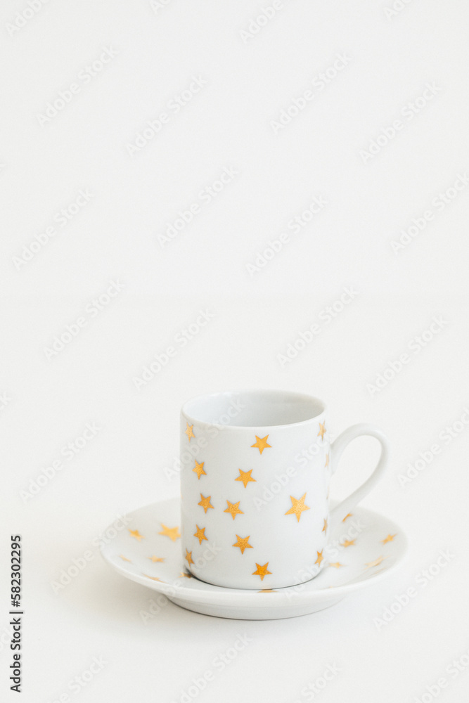 white espresso, Turkish coffee cup with gold stars on white background white espresso, Turkish coffee cup with gold stars on white background
