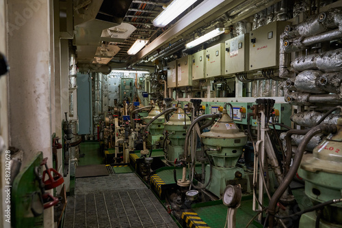 Ship's engine room. Vessel's ( Ship ) Engine Room Space / industrial stairs. Ship's Engine Heavy Machinery Space - Pipes, Valves, Engines