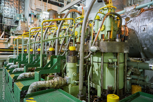 Ship's engine room. Vessel's ( Ship ) Engine Room Space / industrial stairs. Ship's Engine Heavy Machinery Space - Pipes, Valves, Engines