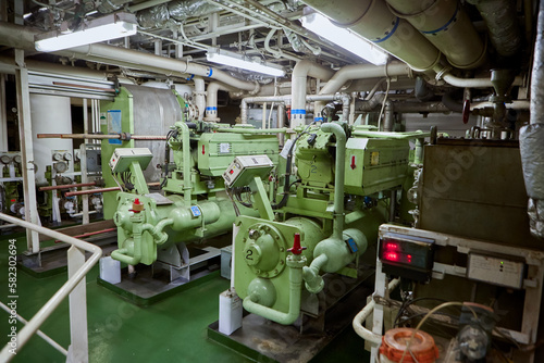 Ship's engine room. Vessel's ( Ship ) Engine Room Space / industrial stairs. Ship's Engine Heavy Machinery Space - Pipes, Valves, Engines