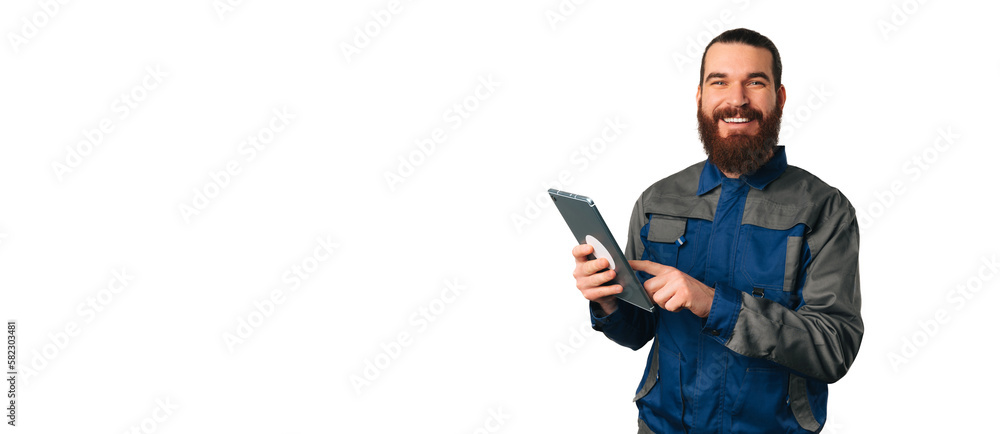 Banner size shot of male engineer smiling and holding a tablet near copy space. Banner size shot of male engineer smiling and holding a tablet near copy space.