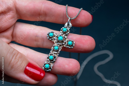 Blue stone cross pendant necklace, vintage jewelry concept, promotional photo for an online jewelry store