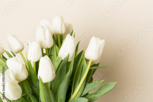 Tulip flowers in vase on wooden table  closeup view