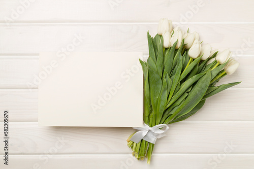 Greeting card mockup with tulips on color background  top view