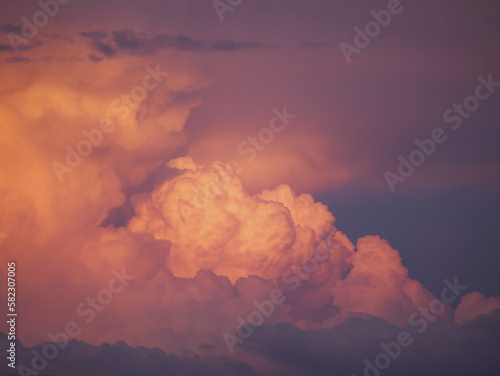 Photos CLOSE UP: Dramatic clouds colored in vibrant pink and blue shades after sunset